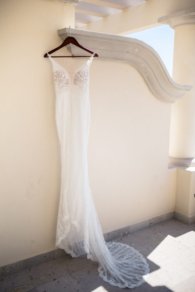 beaded mermaid wedding dress hanging on balcony in Mexico