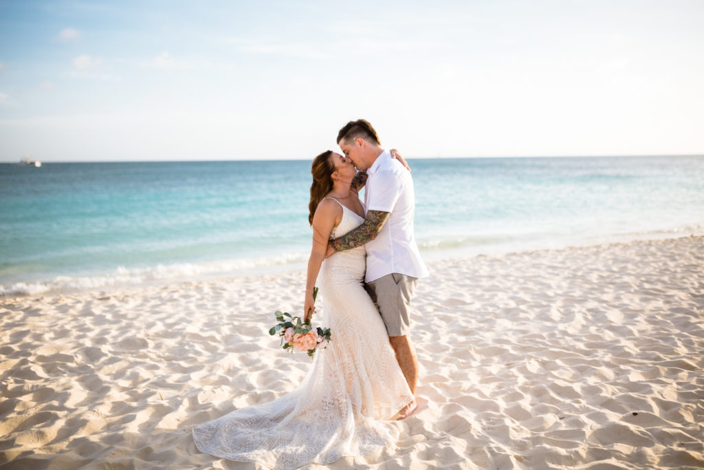 bride and groom kissing on divi beach in aruba