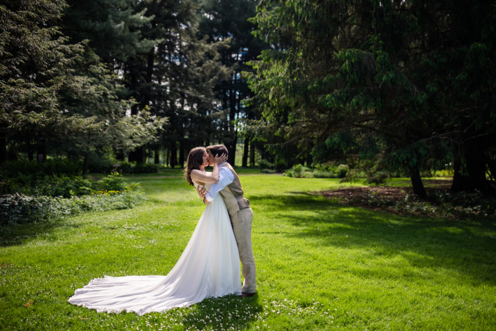 two brides kissing in a park