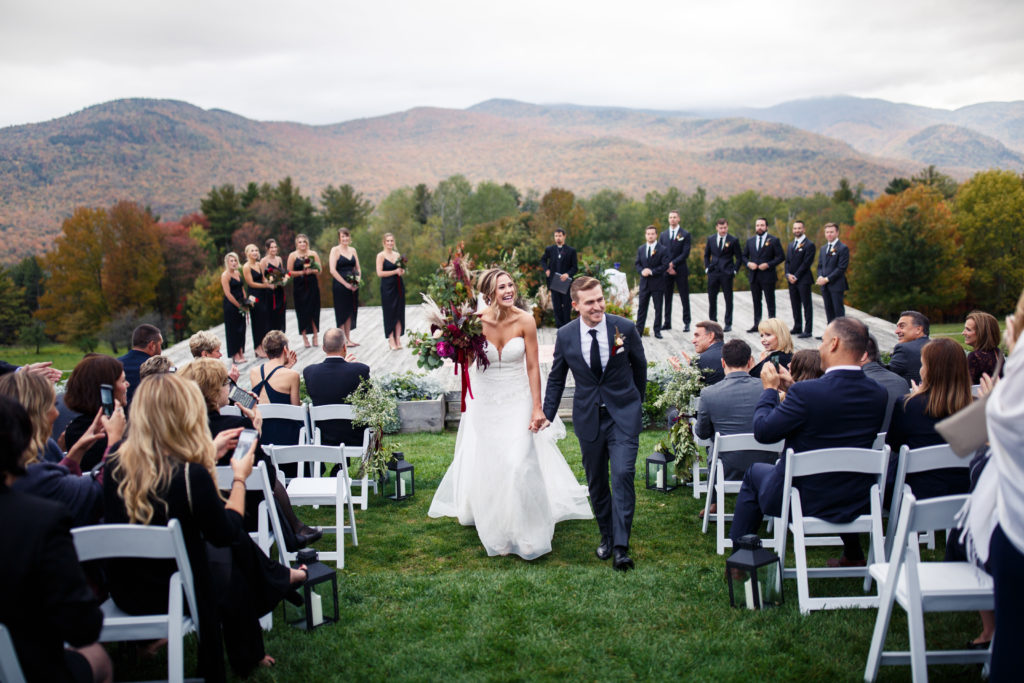 bride and groom walk down the aisle at the trapp family lodge