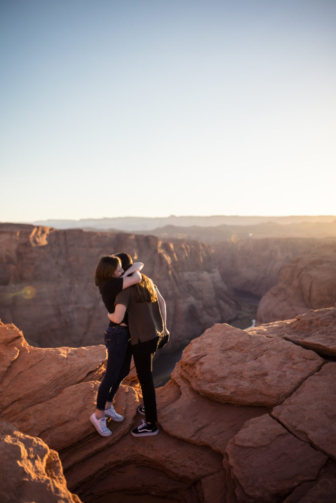 Couple after the proposal sharing an embrace with a gorgeous view of Horseshoe Bend