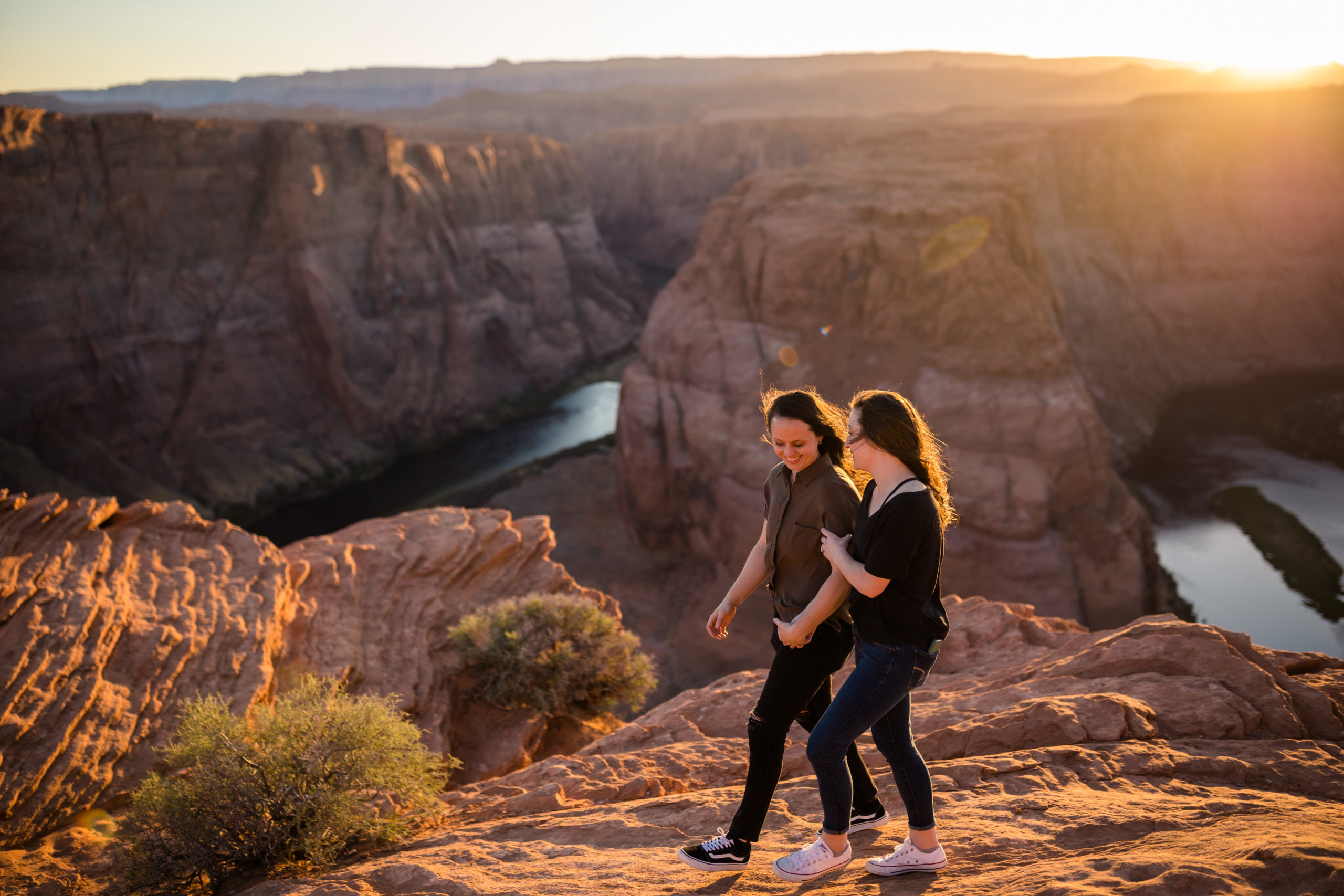 Couple holding hands as they stroll along Horseshoe Bend, captured by Makayla MacGarvey