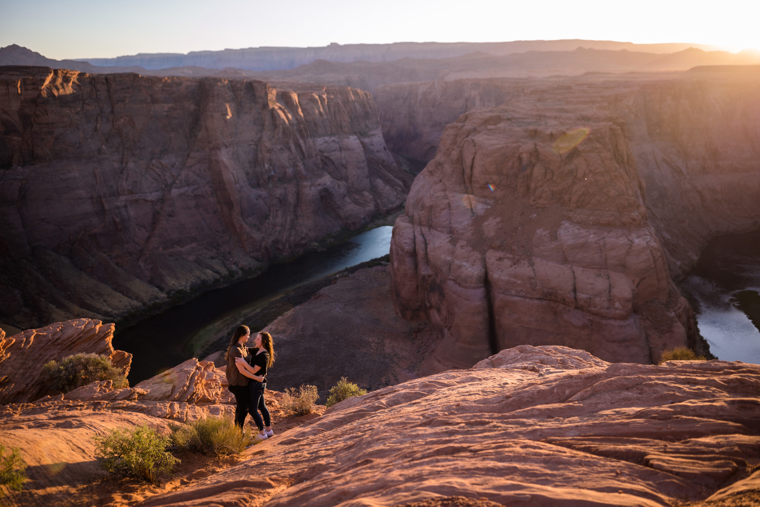 Couple sharing an embrace with a great look out onto Horseshoe Bend, captured by Makayla MacGarvey