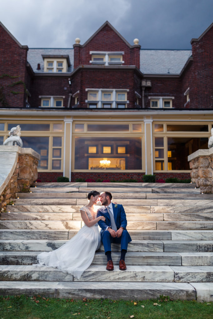 bride and groom in front of wilburton mansion
