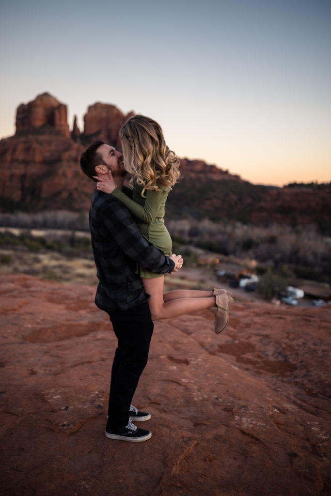 Guy carries the girl and gives her a kiss during their proposal at Sedona, taken by Makayla MacGarvey