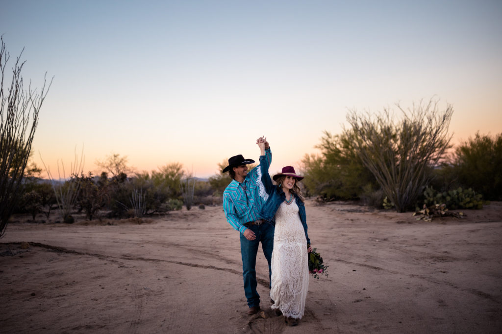 bride and groom dancing in the desert