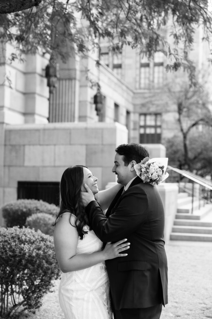 A couple standing in front of the old Phoenix Courthouse on their wedding day.