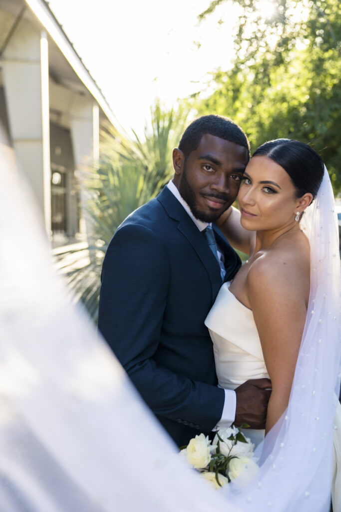 bride and groom in front of clayton house. venue